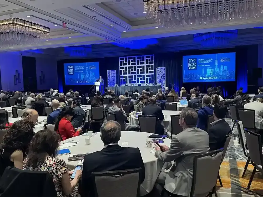 Attendees seated at round tables at the Family Office Club New York Super Summit